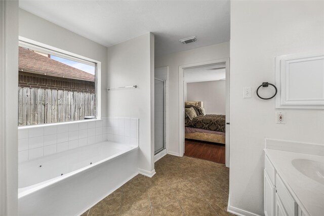 14531 County Cress Dr, Houston, TX 77047 - full bath featuring a jetted tub, tile patterned flooring, vanity, a shower stall, and baseboards