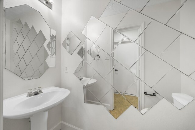 14531 County Cress Dr, Houston, TX 77047 - bathroom featuring a sink and baseboards
