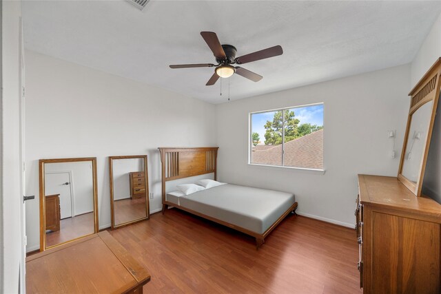 14531 County Cress Dr, Houston, TX 77047 - bedroom featuring light wood finished floors, a ceiling fan, and baseboards