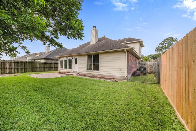 14531 County Cress Dr, Houston, TX 77047 - back of house featuring a patio area, a chimney, brick siding, a gate, and a shingled roof