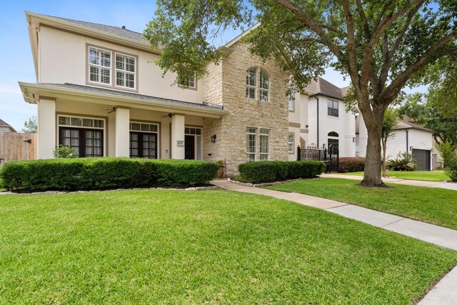 4021 Glenshire St, Houston, TX 77025 - traditional-style home with stucco siding, a ceiling fan, and stone siding