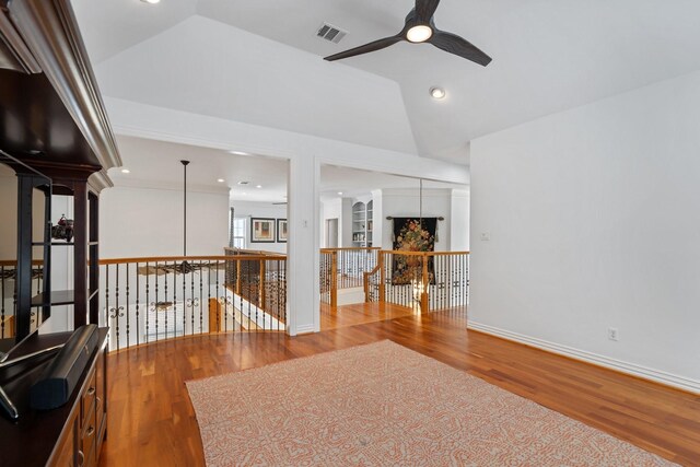 4021 Glenshire St, Houston, TX 77025 - unfurnished room featuring ceiling fan, wood finished floors, vaulted ceiling, baseboards, and ornate columns