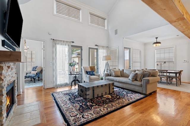 4021 Glenshire St, Houston, TX 77025 - living room featuring a fireplace, wood finished floors, baseboards, and a towering ceiling