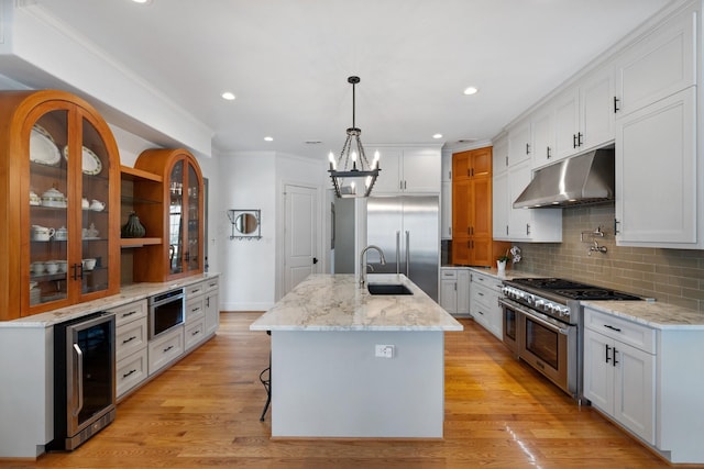 4021 Glenshire St, Houston, TX 77025 - kitchen featuring under cabinet range hood, premium appliances, beverage cooler, a chandelier, and tasteful backsplash