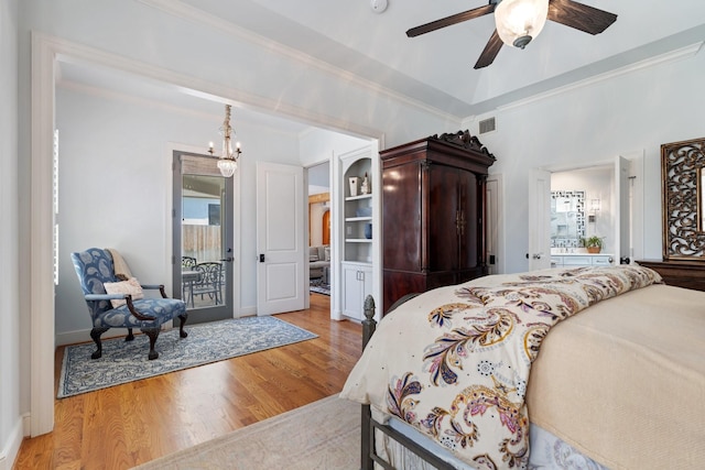 4021 Glenshire St, Houston, TX 77025 - bedroom with wood finished floors, ornamental molding, a chandelier, multiple windows, and access to outside