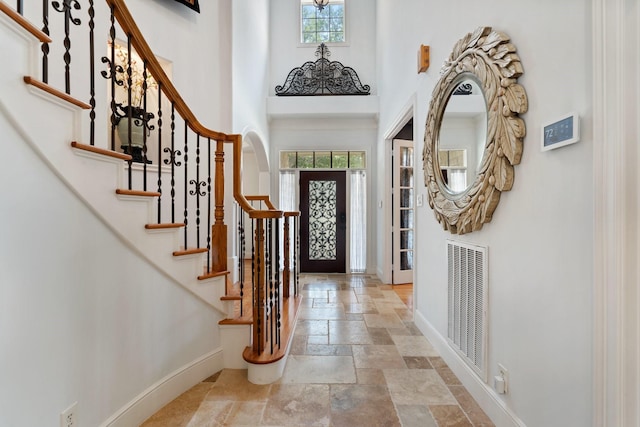 4021 Glenshire St, Houston, TX 77025 - entryway with stone tile floors, baseboards, a towering ceiling, and stairway