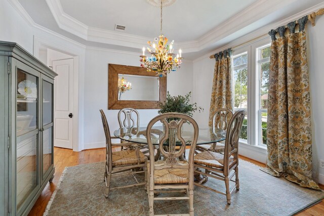 4021 Glenshire St, Houston, TX 77025 - dining space featuring plenty of natural light, light wood finished floors, ornamental molding, a chandelier, and baseboards