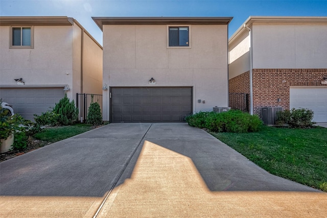 5038 Galahad Ct, Missouri City, TX 77459 - view of front of house featuring stucco siding, an attached garage, concrete driveway, brick siding, and central AC unit