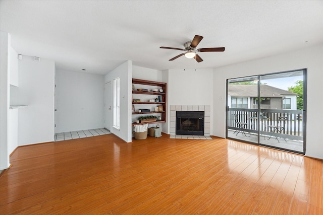 8020 Braesmain Dr Unit 1710, Houston, TX 77025 - unfurnished living room featuring a ceiling fan, wood finished floors, and a fireplace