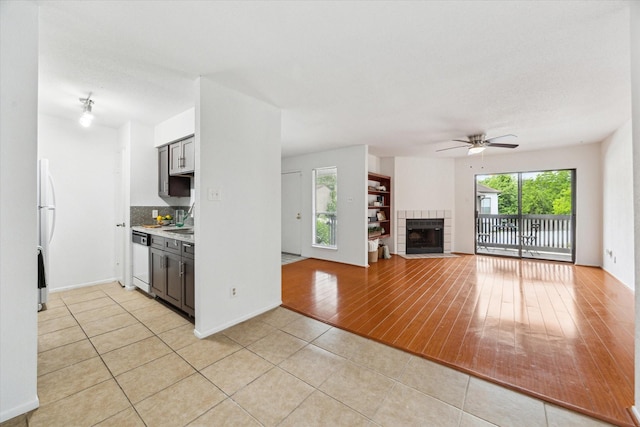 8020 Braesmain Dr Unit 1710, Houston, TX 77025 - kitchen with white appliances, light tile patterned flooring, healthy amount of natural light, and a ceiling fan