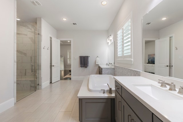 6914 Champion Trl, Katy, TX 77493 - full bath with a stall shower, baseboards, recessed lighting, two vanities, and a tub