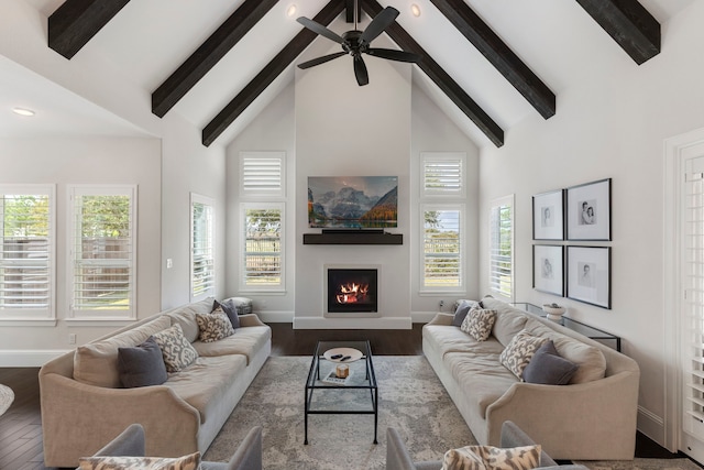 6914 Champion Trl, Katy, TX 77493 - living area with high vaulted ceiling, beamed ceiling, baseboards, a warm lit fireplace, and ceiling fan