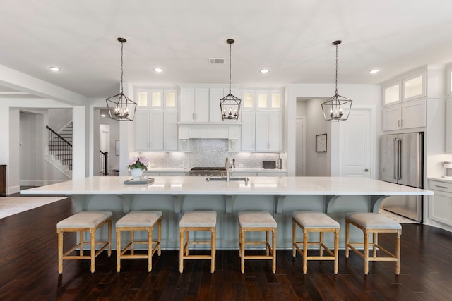 6914 Champion Trl, Katy, TX 77493 - kitchen with high end refrigerator, light countertops, a sink, a large island with sink, and recessed lighting