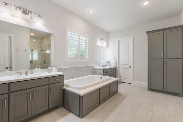 6914 Champion Trl, Katy, TX 77493 - bathroom featuring a shower stall, a bath, two vanities, and recessed lighting