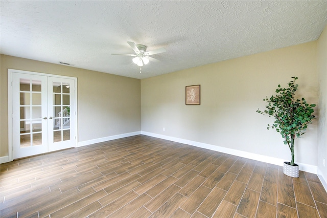 15203 Mcconn St, Houston, TX 77598 - unfurnished room featuring french doors, baseboards, a ceiling fan, wood finished floors, and a textured ceiling