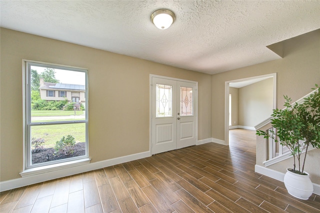 15203 Mcconn St, Houston, TX 77598 - entrance foyer with baseboards, a textured ceiling, and dark wood-type flooring