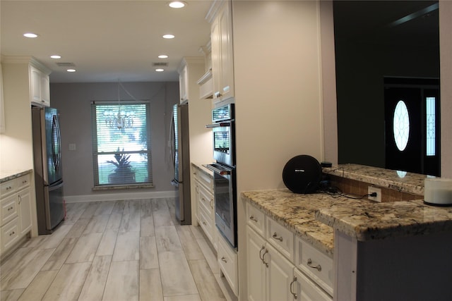 638 Andover St, Spring, TX 77373 - kitchen featuring stainless steel appliances, white cabinetry, recessed lighting, light stone counters, and a chandelier