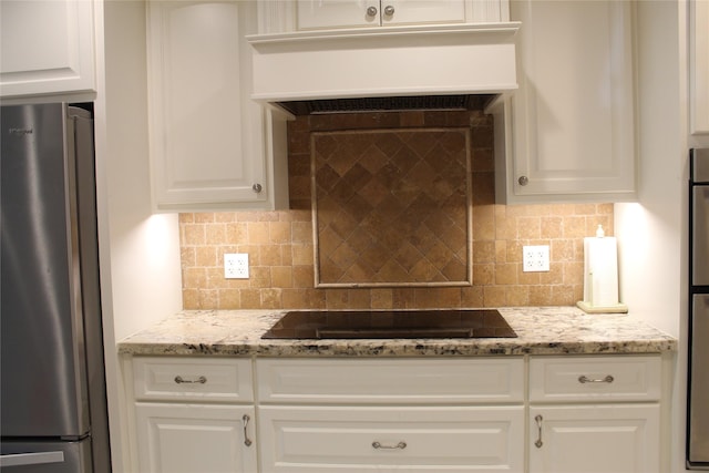 638 Andover St, Spring, TX 77373 - kitchen featuring freestanding refrigerator, under cabinet range hood, black electric stovetop, and white cabinets
