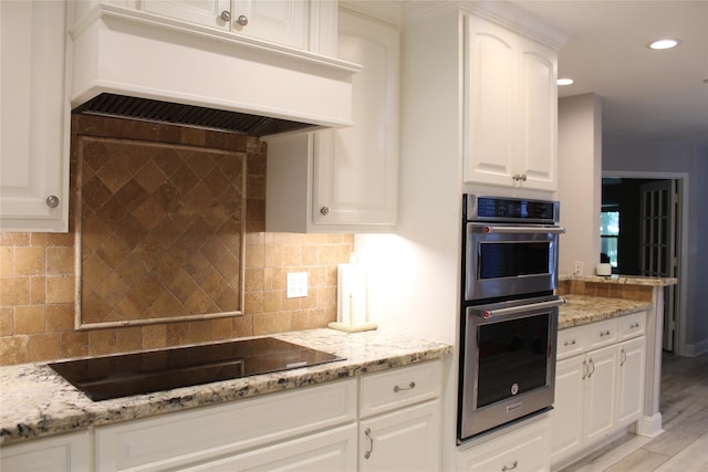 638 Andover St, Spring, TX 77373 - kitchen featuring stainless steel double oven, premium range hood, black electric cooktop, recessed lighting, and backsplash