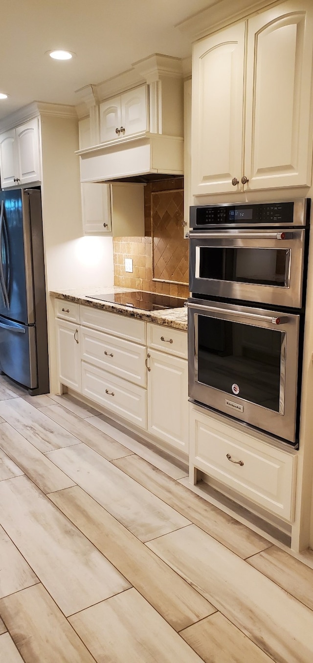 638 Andover St, Spring, TX 77373 - kitchen featuring stainless steel appliances, stone countertops, white cabinetry, backsplash, and ornamental molding