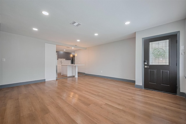 6058 Lyndhurst Dr, Houston, TX 77033 - unfurnished living room with light wood-type flooring, recessed lighting, and baseboards