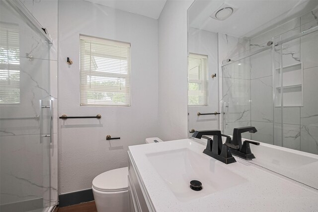 6058 Lyndhurst Dr, Houston, TX 77033 - full bath featuring toilet, a marble finish shower, and vanity