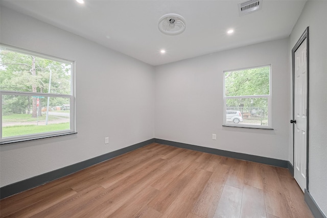6058 Lyndhurst Dr, Houston, TX 77033 - empty room with healthy amount of natural light, light wood-style floors, recessed lighting, and baseboards