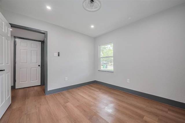 6058 Lyndhurst Dr, Houston, TX 77033 - empty room with light wood-type flooring, recessed lighting, and baseboards