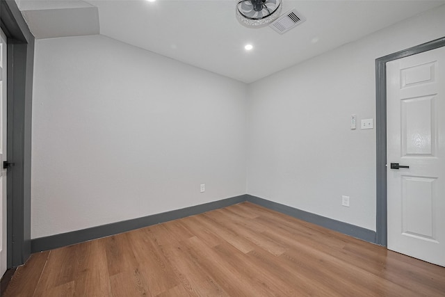 6058 Lyndhurst Dr, Houston, TX 77033 - empty room featuring wood finished floors, vaulted ceiling, recessed lighting, and baseboards