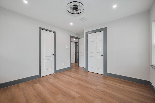6058 Lyndhurst Dr, Houston, TX 77033 - unfurnished bedroom featuring light wood-style floors, baseboards, and recessed lighting