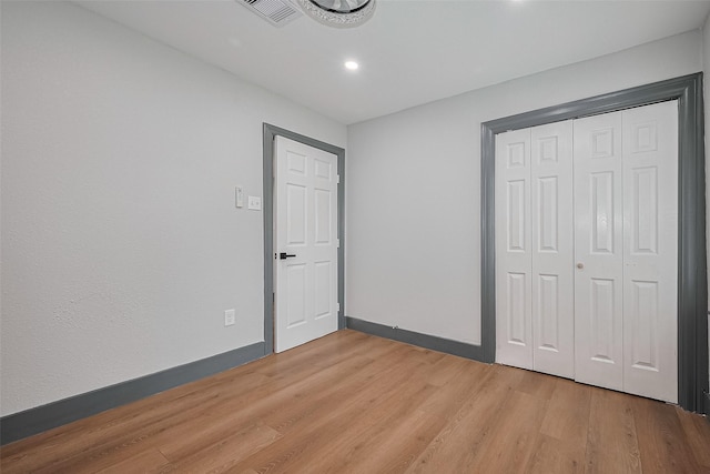 6058 Lyndhurst Dr, Houston, TX 77033 - unfurnished bedroom with light wood-type flooring, recessed lighting, baseboards, and a closet