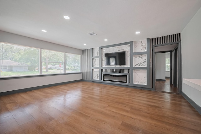 6058 Lyndhurst Dr, Houston, TX 77033 - unfurnished living room with baseboards, wood finished floors, a fireplace, and recessed lighting