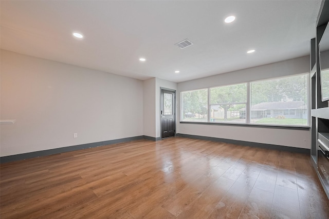 6058 Lyndhurst Dr, Houston, TX 77033 - empty room with wood finished floors, recessed lighting, and baseboards