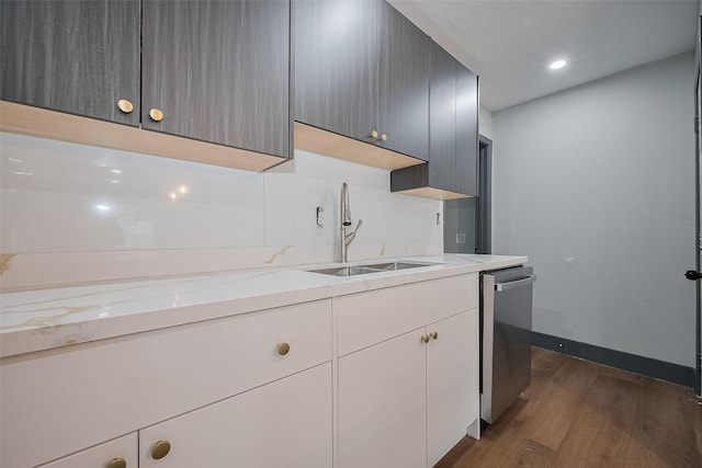 6058 Lyndhurst Dr, Houston, TX 77033 - kitchen featuring dark wood-type flooring, stainless steel dishwasher, a sink, baseboards, and recessed lighting
