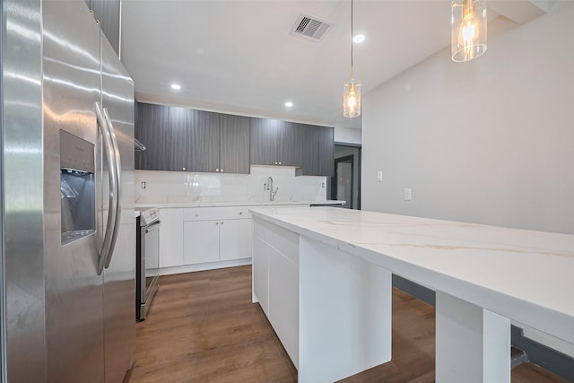 6058 Lyndhurst Dr, Houston, TX 77033 - kitchen with stainless steel fridge, range, recessed lighting, modern cabinets, and light stone countertops