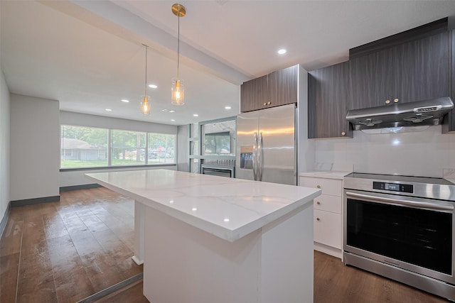 6058 Lyndhurst Dr, Houston, TX 77033 - kitchen featuring appliances with stainless steel finishes, under cabinet range hood, a center island, dark wood-style floors, and modern cabinets