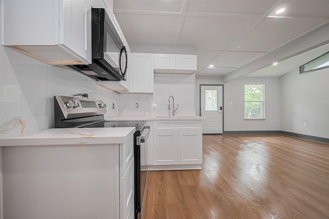 6058 Lyndhurst Dr, Houston, TX 77033 - kitchen featuring stainless steel electric stove, a sink, light wood-type flooring, recessed lighting, and white cabinets
