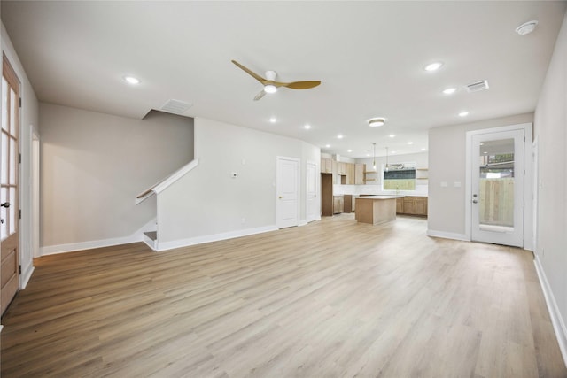 222 Canino Rd A/B, Unit A/B Houston, TX 77076 - unfurnished living room featuring ceiling fan, light wood-style flooring, stairway, baseboards, and recessed lighting