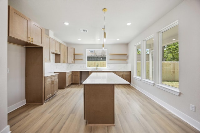 222 Canino Rd A/B, Unit A/B Houston, TX 77076 - kitchen featuring open shelves, a sink, a kitchen island, backsplash, and light wood-style floors