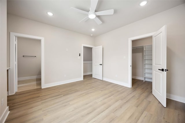 222 Canino Rd A/B, Unit A/B Houston, TX 77076 - unfurnished bedroom featuring a spacious closet, light wood finished floors, a closet, baseboards, and recessed lighting