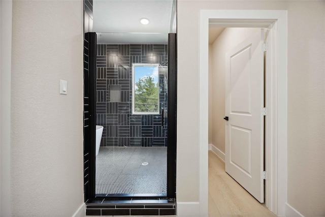 222 Canino Rd A/B, Unit A/B Houston, TX 77076 - bathroom featuring a soaking tub, baseboards, and wood finished floors