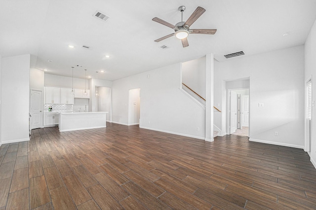 7714 Squall Ln, Baytown, TX 77523 - unfurnished living room with ceiling fan, dark wood-style floors, stairs, recessed lighting, and baseboards