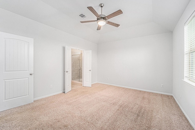 7714 Squall Ln, Baytown, TX 77523 - unfurnished bedroom with light carpet, ensuite bath, lofted ceiling, a ceiling fan, and baseboards