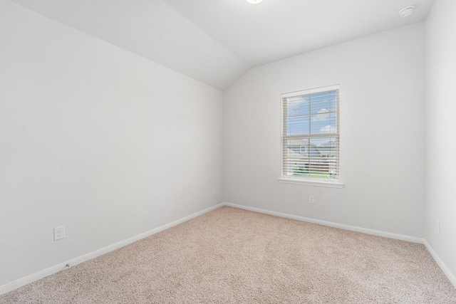 7714 Squall Ln, Baytown, TX 77523 - unfurnished room featuring carpet floors, baseboards, and vaulted ceiling