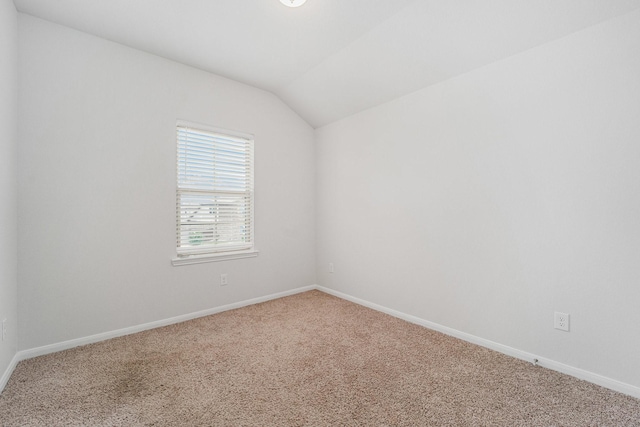 7714 Squall Ln, Baytown, TX 77523 - carpeted spare room with lofted ceiling and baseboards