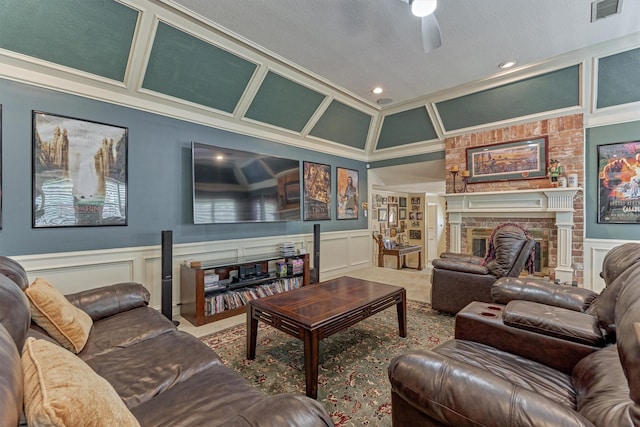 5211 Rothchilde Ct, Houston, TX 77069 - carpeted living area with a decorative wall, a ceiling fan, a brick fireplace, wainscoting, and crown molding