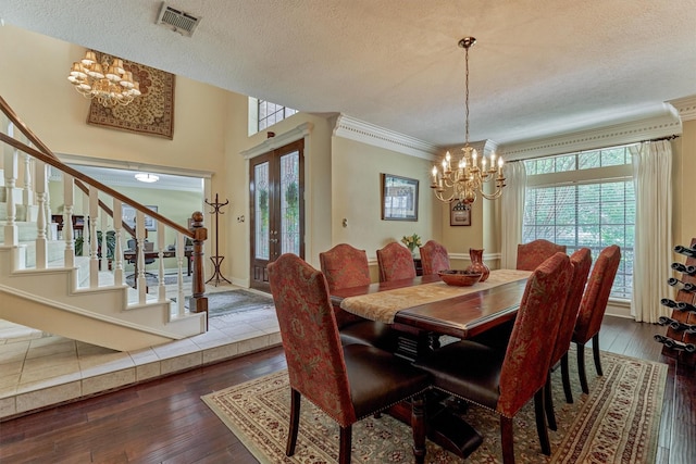 5211 Rothchilde Ct, Houston, TX 77069 - dining space with a chandelier, stairs, plenty of natural light, a textured ceiling, and ornamental molding
