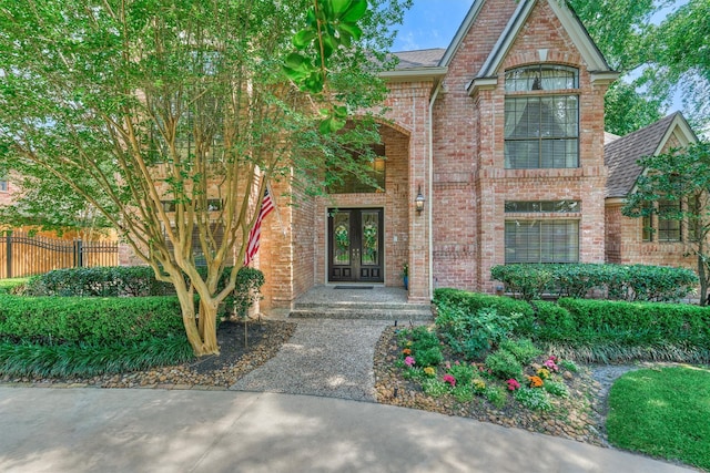 5211 Rothchilde Ct, Houston, TX 77069 - entrance to property featuring french doors, brick siding, and roof with shingles