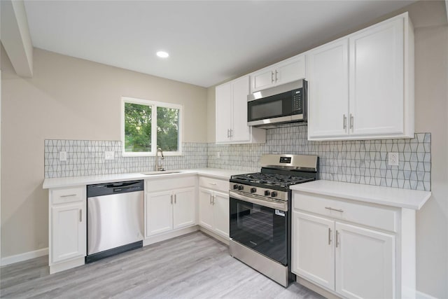 9409 Fairland Dr, Houston, TX 77051 - kitchen with stainless steel appliances, a sink, white cabinets, light countertops, and recessed lighting