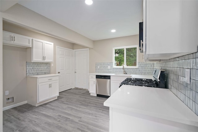 9409 Fairland Dr, Houston, TX 77051 - kitchen with stainless steel dishwasher, range with gas cooktop, white cabinetry, tasteful backsplash, and recessed lighting